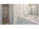 Well-lit bathroom with double sinks, modern fixtures, and access to a walk-in closet at 291 Hanging Elm Ln, Fuquay Varina, NC 27526