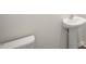 Clean half-bathroom featuring a pedestal sink and standard toilet at 291 Hanging Elm Ln, Fuquay Varina, NC 27526