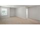 A large, airy room with neutral carpet, natural light, and light colored walls at 291 Hanging Elm Ln, Fuquay Varina, NC 27526