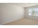 An efficiently designed bedroom with neutral carpet and a window with outdoor views at 291 Hanging Elm Ln, Fuquay Varina, NC 27526