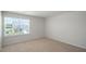 Well-lit bedroom featuring neutral carpet and a window with pleasant outdoor views at 291 Hanging Elm Ln, Fuquay Varina, NC 27526