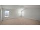 Large carpeted bedroom with three windows providing ample natural light at 291 Hanging Elm Ln, Fuquay Varina, NC 27526