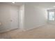 Bright bedroom featuring neutral carpet, natural light, and a convenient ensuite door at 291 Hanging Elm Ln, Fuquay Varina, NC 27526