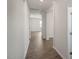 Bright hallway with wood-look floors and white walls, leading to rooms in the home at 291 Hanging Elm Ln, Fuquay Varina, NC 27526