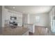 Bright kitchen featuring an island, granite countertops, and stainless steel appliances at 291 Hanging Elm Ln, Fuquay Varina, NC 27526