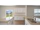 Kitchen with granite countertops, stainless appliances, and a view of the backyard at 291 Hanging Elm Ln, Fuquay Varina, NC 27526