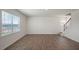 Bright living room with hardwood floors, large windows, and stairway access at 291 Hanging Elm Ln, Fuquay Varina, NC 27526