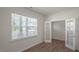 Bright living room with natural light, wood-look floors, and view to another room via glass French doors at 291 Hanging Elm Ln, Fuquay Varina, NC 27526