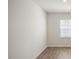 Neutral room with light walls, wood-look floors, and a window at 291 Hanging Elm Ln, Fuquay Varina, NC 27526