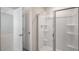 Bathroom showcasing a glass-enclosed shower with built-in shelves and a door to another room at 291 Hanging Elm Ln, Fuquay Varina, NC 27526