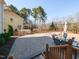 Expansive backyard features a stone patio, outdoor seating, and mature trees, perfect for entertaining at 3059 Hyco Lake Ct, Fuquay Varina, NC 27526