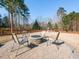 Relaxing backyard featuring a stone fire pit surrounded by comfortable seating, ideal for gatherings at 3059 Hyco Lake Ct, Fuquay Varina, NC 27526