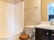 Well-maintained bathroom with a shower-tub combination and black cabinets at 3059 Hyco Lake Ct, Fuquay Varina, NC 27526