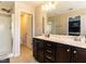 Bright bathroom features a double vanity, a walk-in shower, and linen storage at 3059 Hyco Lake Ct, Fuquay Varina, NC 27526