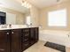 A spacious bathroom featuring a soaking tub, a double vanity, and tile flooring at 3059 Hyco Lake Ct, Fuquay Varina, NC 27526