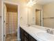Bathroom featuring double sinks with shower and toilet through the door at 3059 Hyco Lake Ct, Fuquay Varina, NC 27526