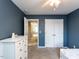 Bedroom with neutral carpet features a dresser and a closet for extra storage at 3059 Hyco Lake Ct, Fuquay Varina, NC 27526