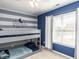This bedroom has a bunk bed, modern decor, and a large window at 3059 Hyco Lake Ct, Fuquay Varina, NC 27526