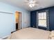Comfortable bedroom features a ceiling fan, window, and access to an adjoining bathroom at 3059 Hyco Lake Ct, Fuquay Varina, NC 27526