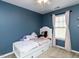 A cozy bedroom featuring soft pink accents and neutral carpeting at 3059 Hyco Lake Ct, Fuquay Varina, NC 27526