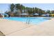 Community pool offers multiple seating areas and water features for hours of summer fun at 3059 Hyco Lake Ct, Fuquay Varina, NC 27526