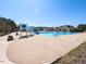 Community pool with a slide and plenty of room for swimming and lounging in the sun at 3059 Hyco Lake Ct, Fuquay Varina, NC 27526