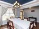 Dining room featuring a large window, elegant curtains, and a view into the entryway at 3059 Hyco Lake Ct, Fuquay Varina, NC 27526