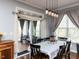 Bright dining room featuring elegant lighting, access to a screened in porch and neutral paint at 3059 Hyco Lake Ct, Fuquay Varina, NC 27526