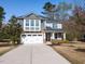 Inviting two-story home with a two-car garage and a long driveway leading up to the house at 3059 Hyco Lake Ct, Fuquay Varina, NC 27526