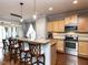 Open concept kitchen with granite countertops, stainless steel appliances, and bar seating at 3059 Hyco Lake Ct, Fuquay Varina, NC 27526