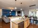 Spacious kitchen with a granite island, stainless steel dishwasher, and a view into the living and dining areas at 3059 Hyco Lake Ct, Fuquay Varina, NC 27526