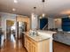 Open kitchen design with granite counters, stainless appliances and warm wood flooring at 3059 Hyco Lake Ct, Fuquay Varina, NC 27526