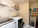 Functional laundry room with shelving and modern washing machine and dryer at 3059 Hyco Lake Ct, Fuquay Varina, NC 27526