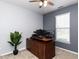 Bright home office with a modern adjustable desk setup and ample natural light, perfect for remote work at 3059 Hyco Lake Ct, Fuquay Varina, NC 27526