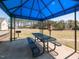 Community picnic shelter featuring grill and picnic table with neighborhood pool in background at 3059 Hyco Lake Ct, Fuquay Varina, NC 27526