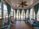 Inviting sunroom with rocking chairs and ample natural light filtering through the large windows at 3059 Hyco Lake Ct, Fuquay Varina, NC 27526