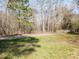 Picturesque walking path surrounded by lush greenery, inviting residents to enjoy nature and outdoor activities at 3059 Hyco Lake Ct, Fuquay Varina, NC 27526