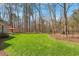 Expansive back yard featuring lush lawn, mature trees, and outdoor seating area at 3120 A Timberlyne Dr, Mebane, NC 27302