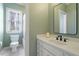 A clean bathroom with a modern sink, mirror, and a window allowing natural light to brighten the space at 3120 A Timberlyne Dr, Mebane, NC 27302