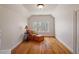 Cozy bedroom with hardwood floors, a comfortable chair, and natural light at 3120 A Timberlyne Dr, Mebane, NC 27302