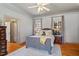 Comfortable bedroom featuring a ceiling fan, hardwood floors, and windows with stylish curtains at 3120 A Timberlyne Dr, Mebane, NC 27302