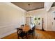 Bright dining room featuring hardwood floors, a chandelier and views of trees outside at 3120 A Timberlyne Dr, Mebane, NC 27302