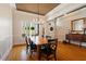 Well-lit dining room showcasing hardwood floors, chandelier and large window views at 3120 A Timberlyne Dr, Mebane, NC 27302