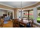 A dining room featuring a wood table and chairs, connecting to an outdoor patio with comfortable seating at 3120 A Timberlyne Dr, Mebane, NC 27302