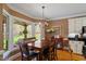 Inviting dining area with wood floors, large windows offering scenic outdoor views and a stylish chandelier at 3120 A Timberlyne Dr, Mebane, NC 27302