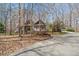Home exterior amid trees with lush lawn and landscaping on a sunny day at 3120 A Timberlyne Dr, Mebane, NC 27302