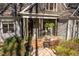 Charming front porch with rocking chairs, lush plants, and classic architectural design at 3120 A Timberlyne Dr, Mebane, NC 27302