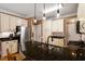 Modern kitchen with granite countertops, stainless steel appliances, and bar seating for casual dining and entertaining at 3120 A Timberlyne Dr, Mebane, NC 27302