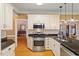 A gourmet kitchen with stainless steel appliances, granite countertops, and white cabinets for a modern look at 3120 A Timberlyne Dr, Mebane, NC 27302