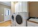 Convenient laundry room with washer, dryer, utility sink, and storage cabinets at 3120 A Timberlyne Dr, Mebane, NC 27302